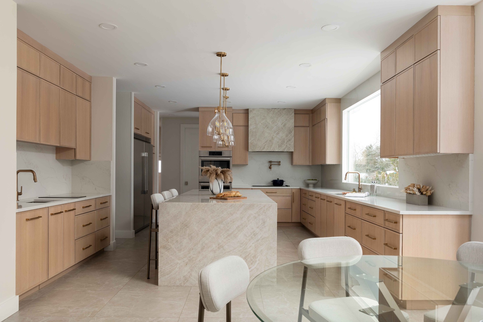 Finished custom kitchen with layered cabinetry and quartz counters.